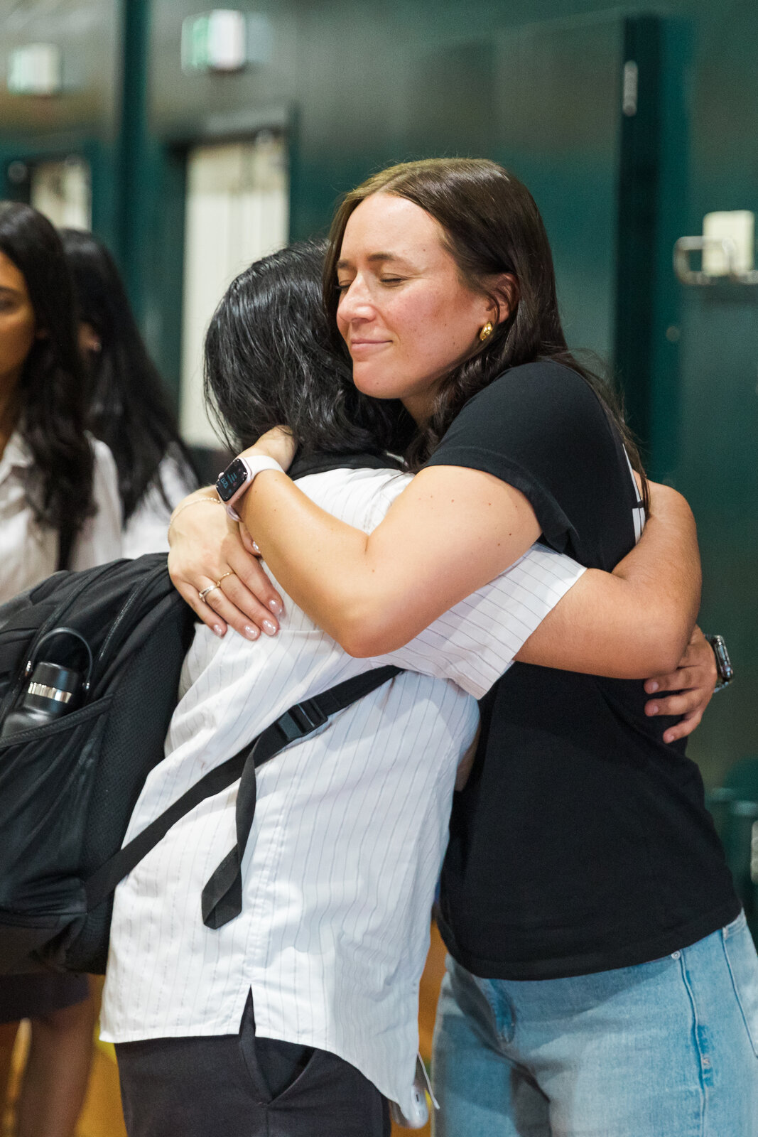 Jazz Thornton hugging a student after a Voices of Hope school visit